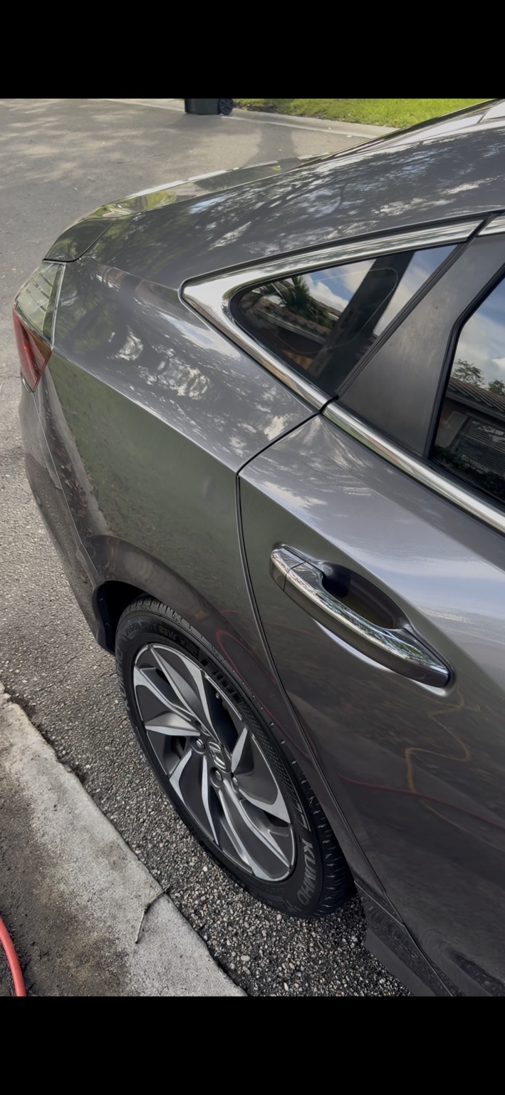 Gray sedan quarter panel and wheel