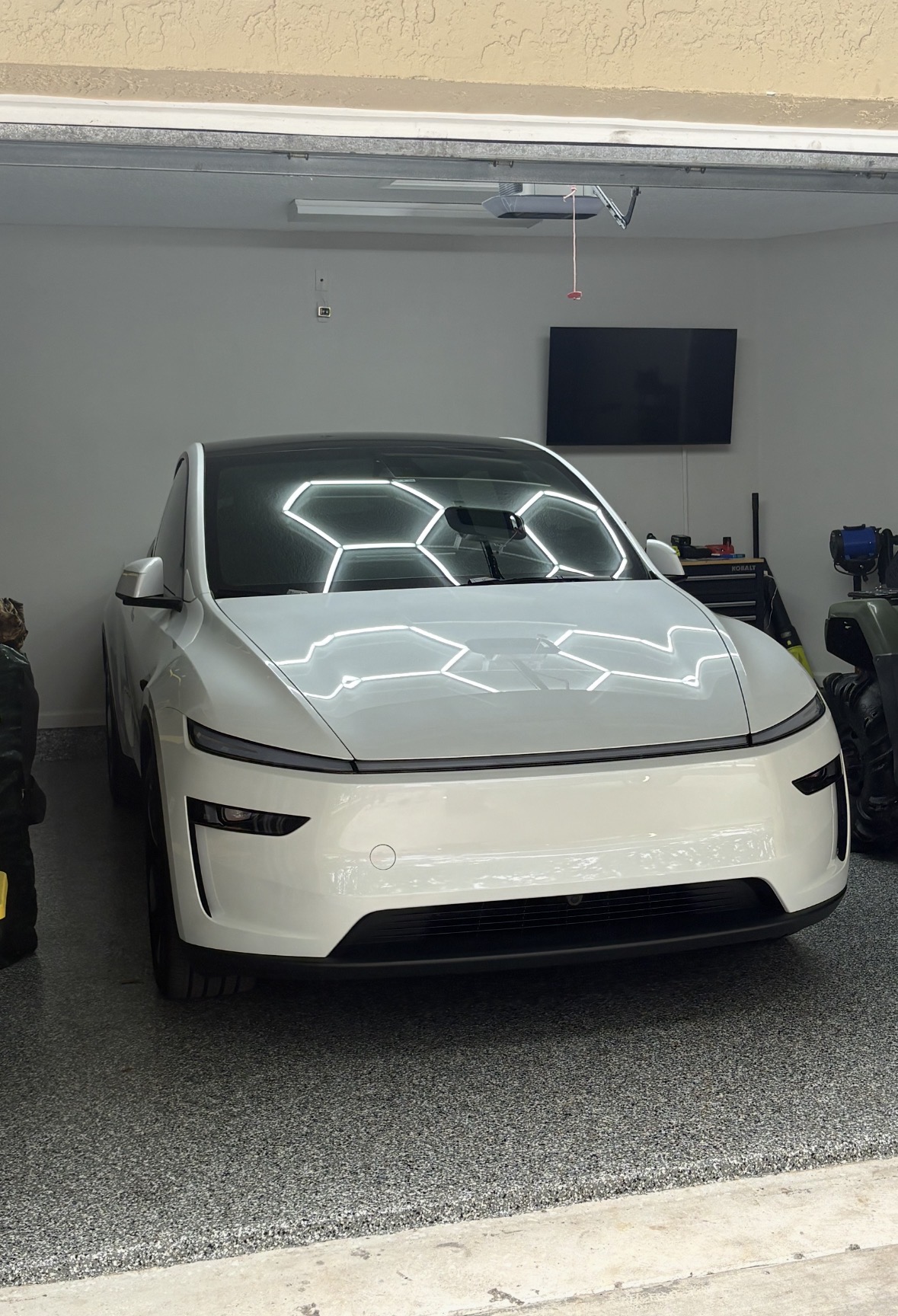 White vehicle in detailing garage